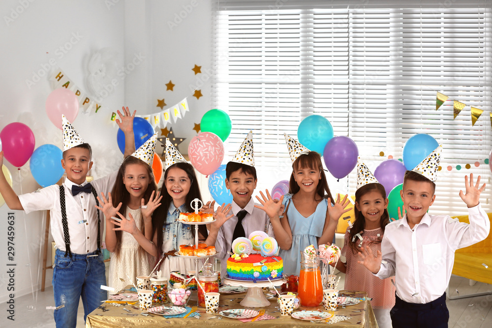 Happy children at birthday party in decorated room - obrazy, fototapety, plakaty 