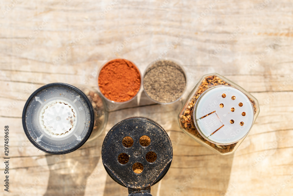 Spice jars with different lids for sprinkling food top view Spice jars with different lids for sprinkling food top view