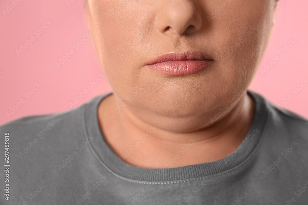 Woman with double chin on pink background, closeup Woman with double chin on pink background, closeup