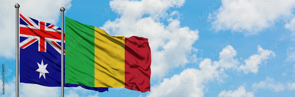 Obraz premium Australia and Mali flag waving in the wind against white cloudy blue sky together. Diplomacy concept, international relations.