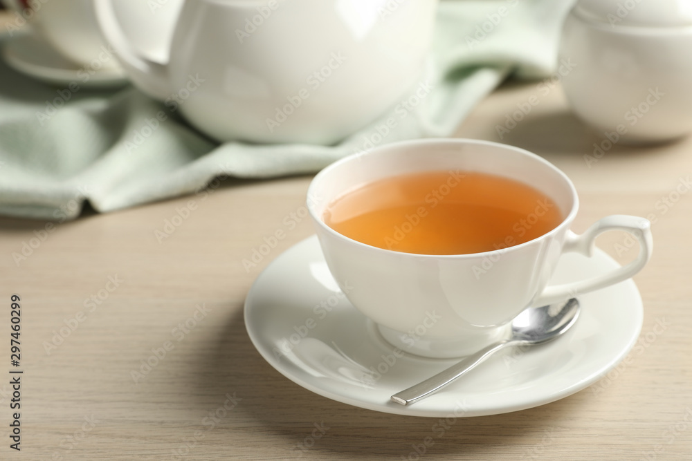 Cup of hot green tea on wooden table Cup of hot green tea on wooden table
