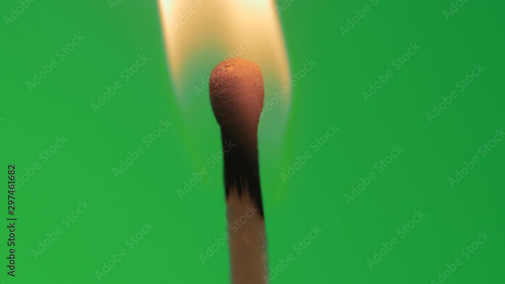 Safety match head lights up in macro or close up on green screen background Safety match head lights up in macro or close up on green screen background