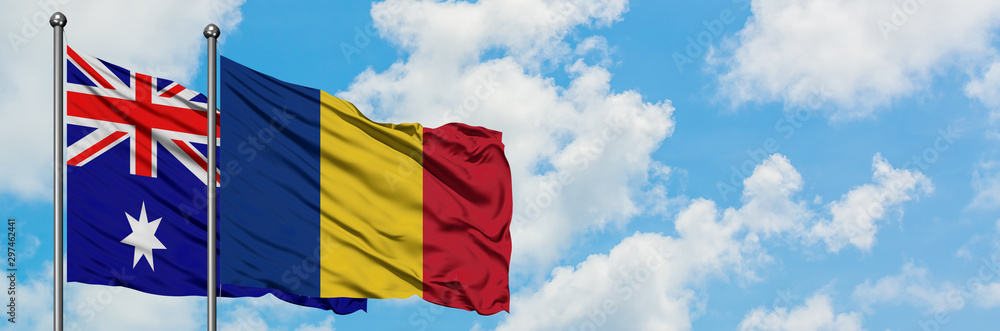 Obraz premium Australia and Romania flag waving in the wind against white cloudy blue sky together. Diplomacy concept, international relations.