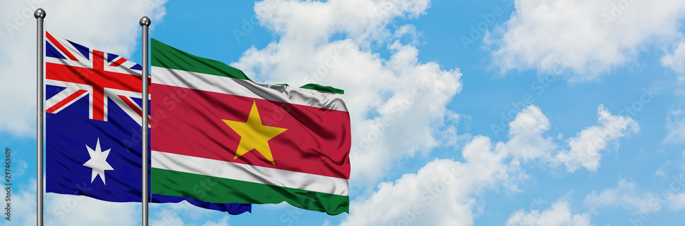 Australia and Suriname flag waving in the wind against white cloudy blue sky together. Diplomacy concept, international relations. Australia and Suriname flag waving in the wind against white cloudy blue sky together. Diplomacy concept, international relations.