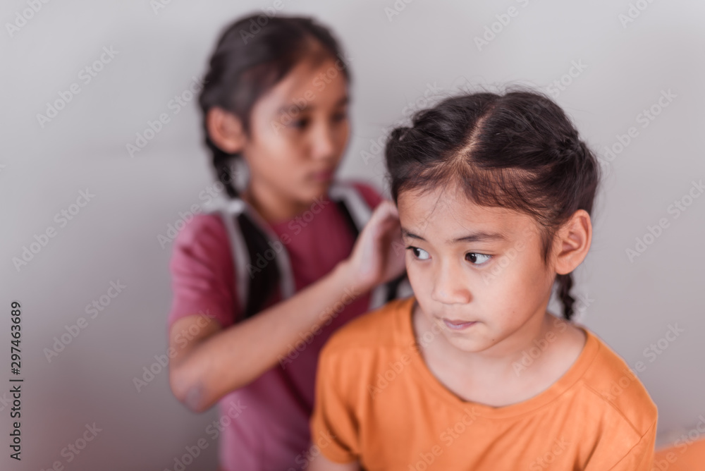 Asian elder sister are making braids for her young sister. Asian elder sister are making braids for her young sister.