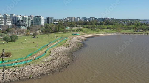 Modern City warterfront. Aerial slow backward. North of Buenos Aires capital city from the river. Skyline, modern buildings, corporative towers, financial district, coastal park, river. Argentina photo