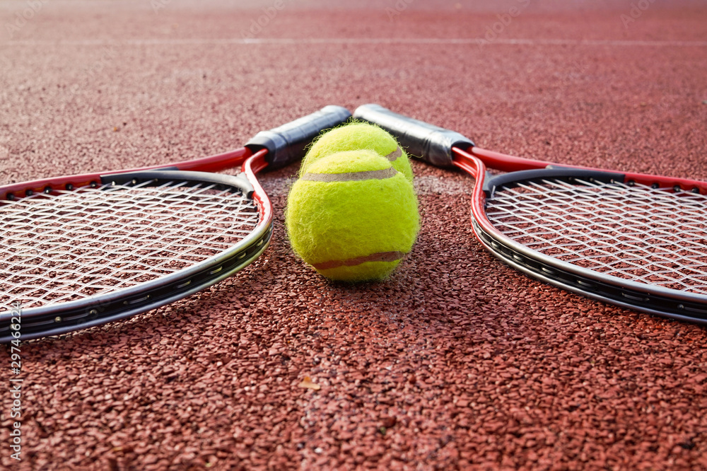 Low angle view tennis scene with balls and racquet