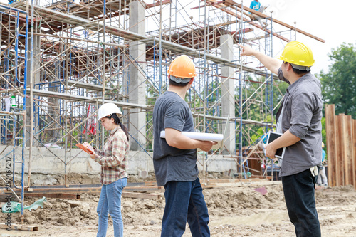 Construction concept of Engineer and Architect working at Construction Site with blue print