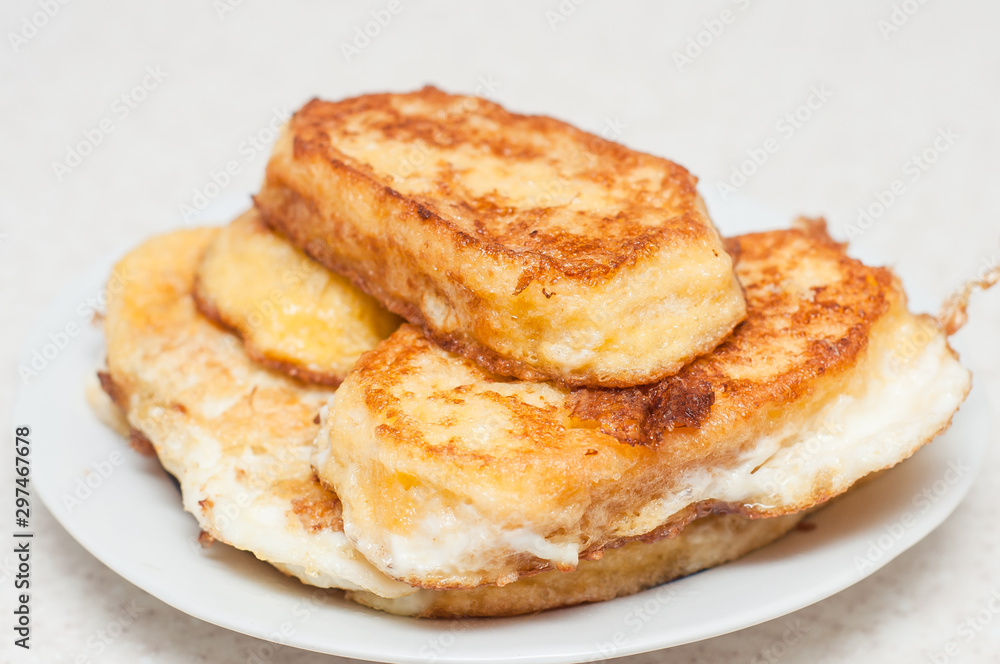 Cooking fried croutons of white bread and beaten eggs in a pan. Preventing spoiled bread.