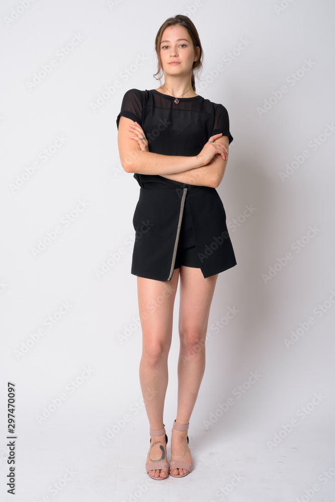 Fototapeta premium Full body shot of young beautiful woman with arms crossed
