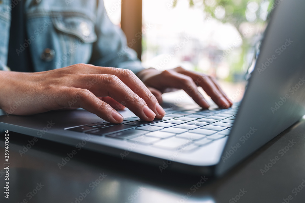 Closeup image of a woman working and typing on laptop computer keyboard Closeup image of a woman working and typing on laptop computer keyboard