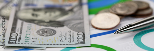 Silver pen lying on desk cash dollar plots photo