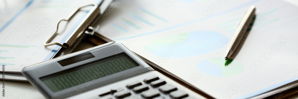 Silver calculator with gray keyboard is lying Silver calculator with gray keyboard is lying