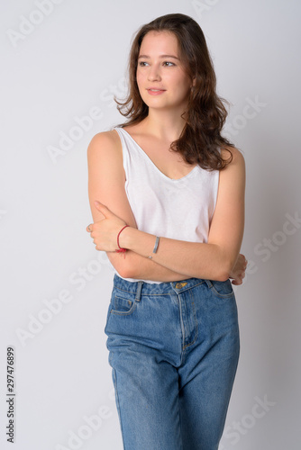 Portrait of happy young beautiful woman thinking with arms crossed