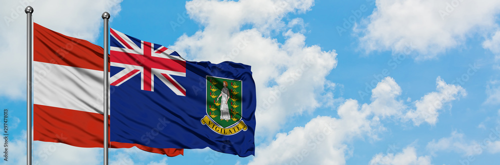 Fototapeta premium Austria and British Virgin Islands flag waving in the wind against white cloudy blue sky together. Diplomacy concept, international relations.