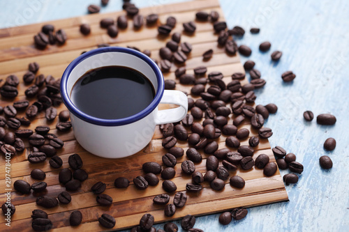 Coffee in cup and coffee bean on rustic table with a blank space for a text, Espresso in cup on blue background