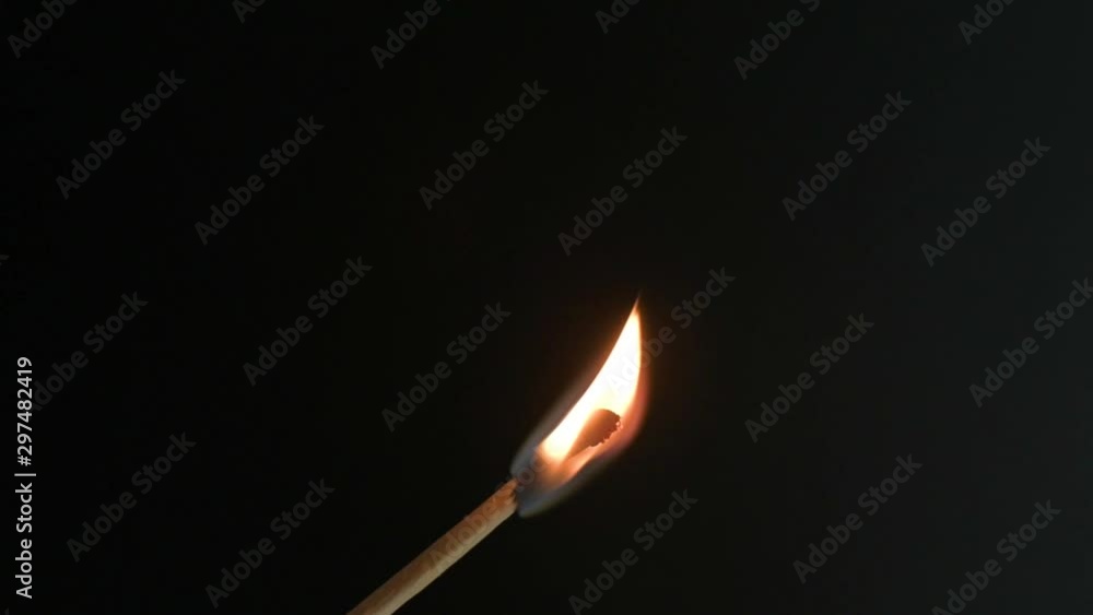 Close view of burning match facing up on black background. Close view of burning match facing up on black background.