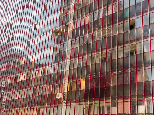 Glass wall of a large residential building. The theme of an emerging housing market under construction