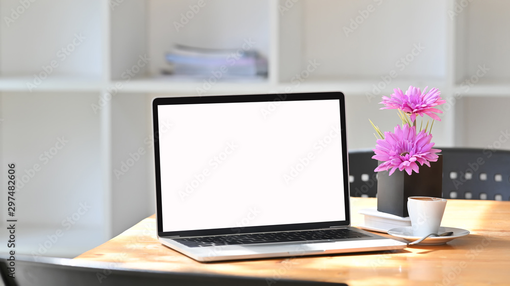Comfortable workspace with laptop, coffee and flower. Comfortable workspace with laptop, coffee and flower.