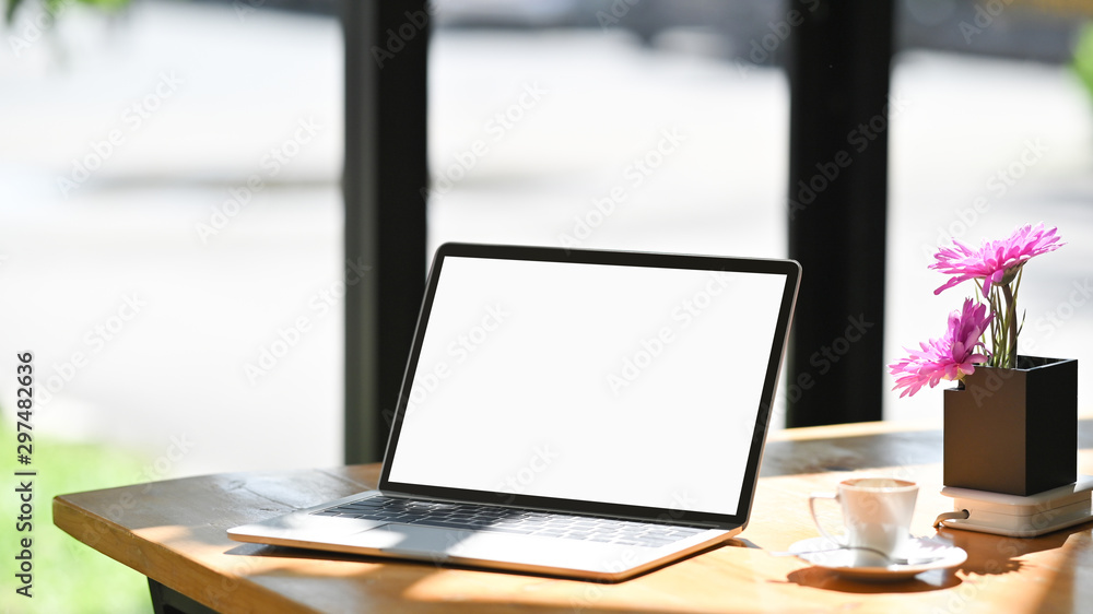 Open blank screen laptop computer in comfortable workspace with flower pot. Open blank screen laptop computer in comfortable workspace with flower pot.