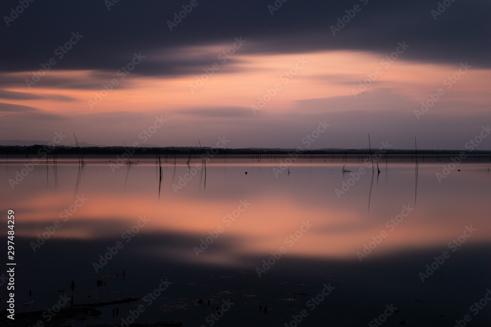 Beautiful and symmetric sunset over Trasimeno lake (Umbria, Italy) Beautiful and symmetric sunset over Trasimeno lake (Umbria, Italy)