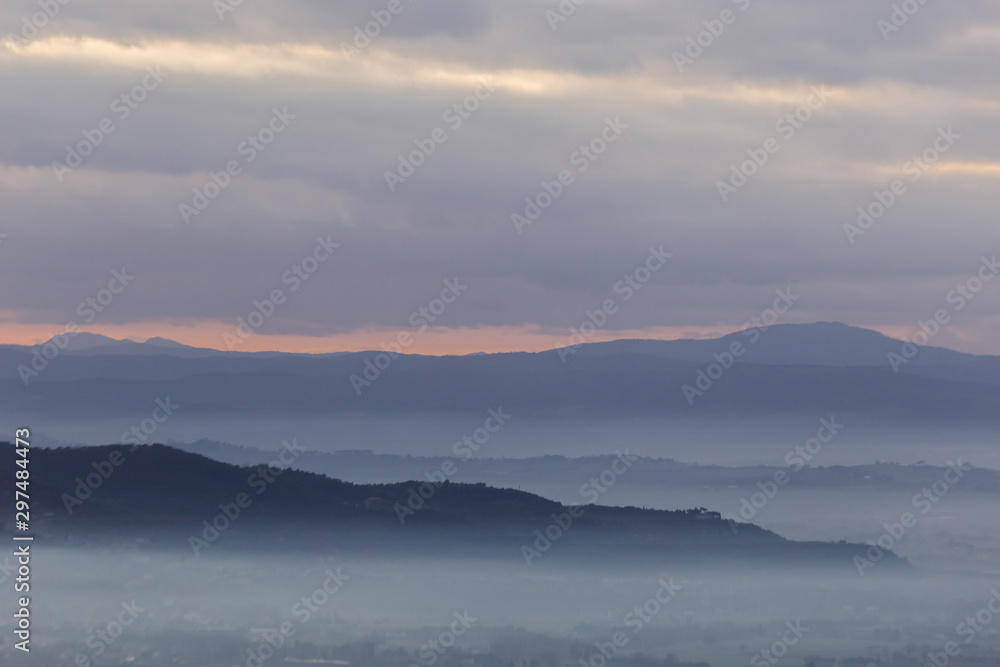 A view of Umbria valley with hills and fog