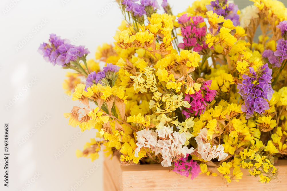 bouquet of autumn colorful bright dried flowers (limonium, Sea lavender) in a wooden box on a white background, close up, copy space bouquet of autumn colorful bright dried flowers (limonium, Sea lavender) in a wooden box on a white background, close up, copy space
