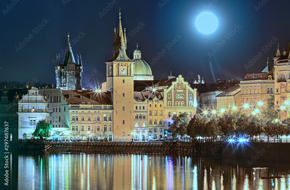 Scenic summer evening view of the Old Town ancient architecture and Vltava river pier in Prague, Czech Republic