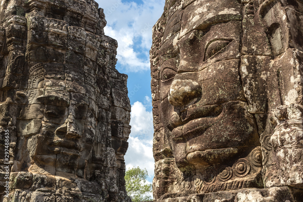 Faces carved in stone in Bayon temple towers, Angkor Wat complex, Cambodia, Siem Reap