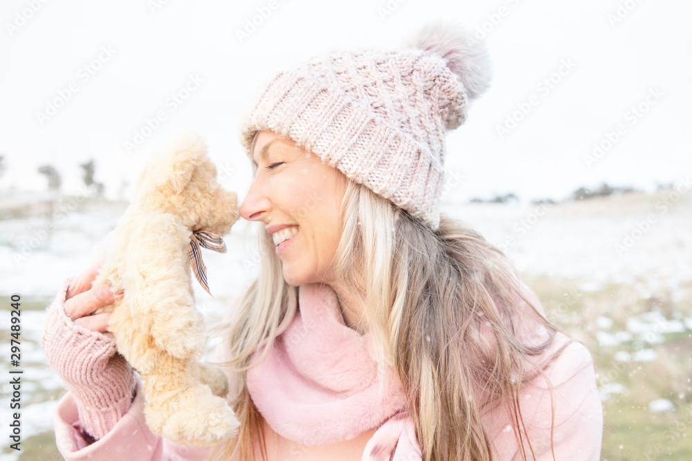 Smiling woman nose to nose with teddy bear Smiling woman nose to nose with teddy bear