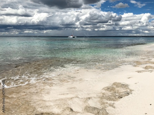 Beach, Sea, Cloudy Sky and Small Yacht
