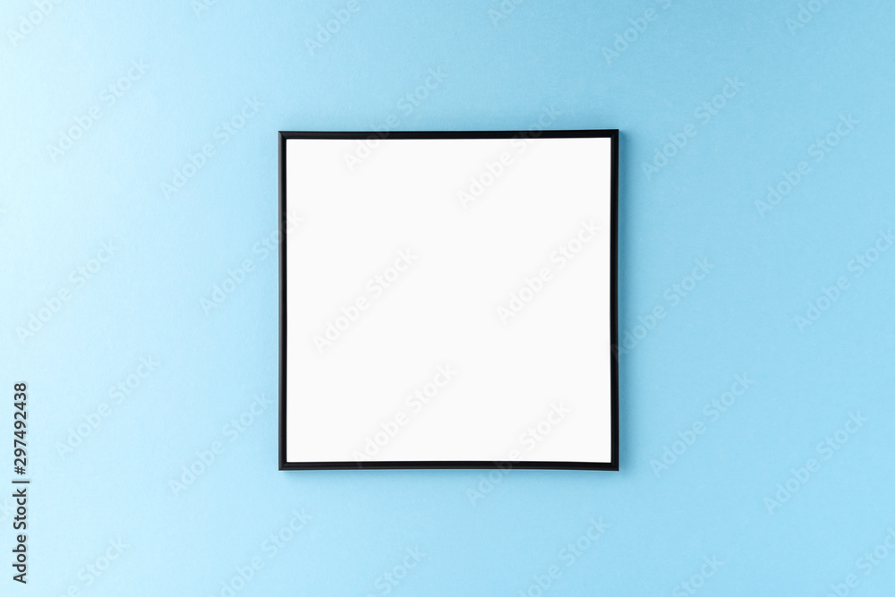Black picture frame on blue background. Mockup with copyspace Black picture frame on blue background. Mockup with copyspace