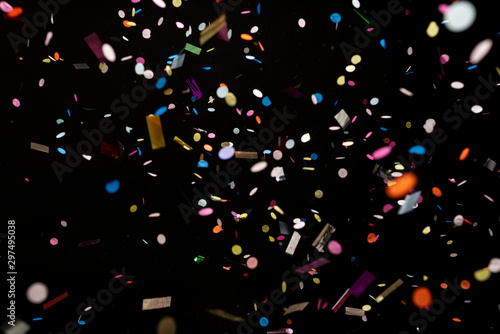colorful party confetti flying in front of black