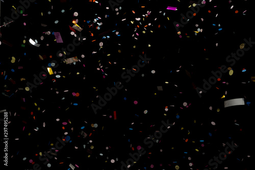 colorful party confetti flying in front of black