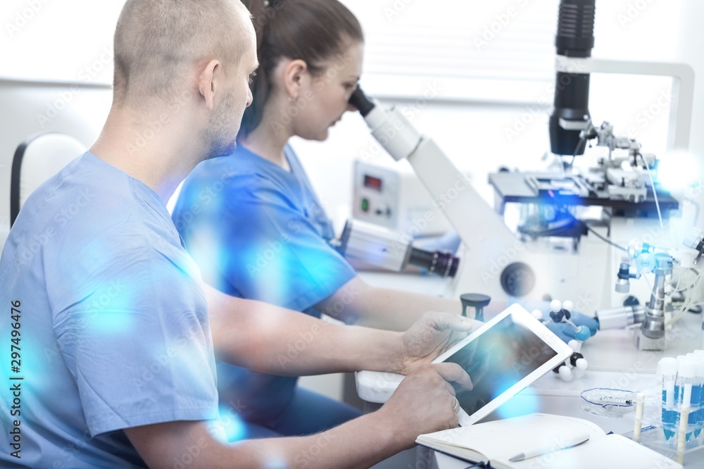 Female Scientist Working with Microscope in Laboratory Female Scientist Working with Microscope in Laboratory