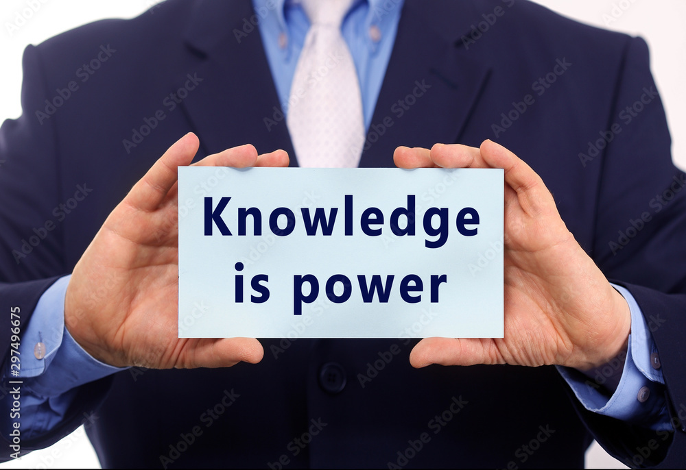 Business man hold paper knowledge is power on it Business man hold paper knowledge is power on it