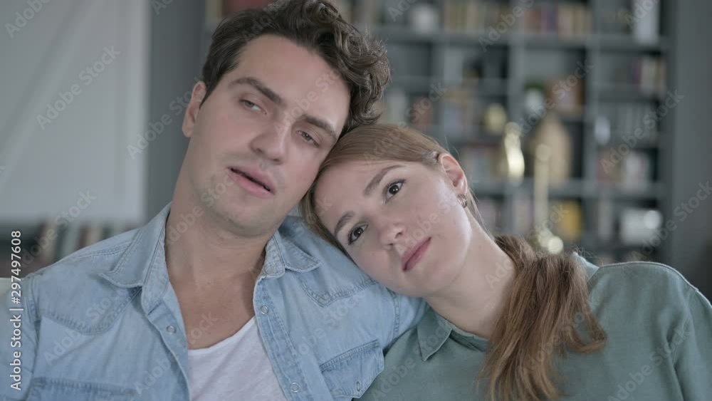 Somber Couple Resting on Each other's Shoulder and Thinking Somber Couple Resting on Each other's Shoulder and Thinking
