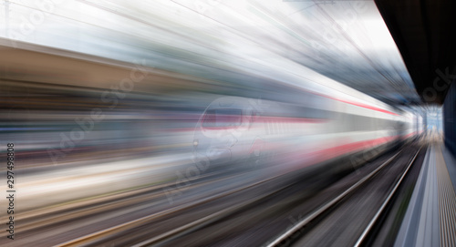High speed train runs on rail tracks . Train in motion © muratart