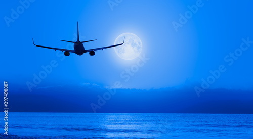 Night sky with moon in the clouds with airplane "Elements of this image furnished by NASA © muratart