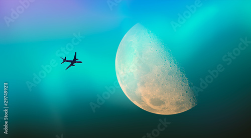 Fototapeta Naklejka Na Ścianę i Meble -  Passenger airplane in the sky against blue full moon and aurora borealis 
