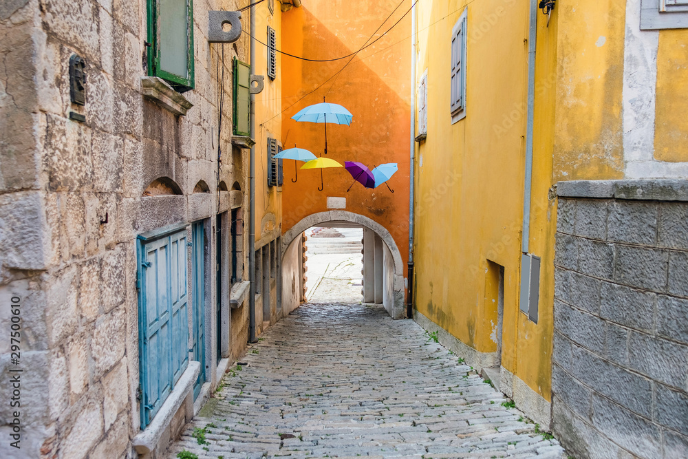 Croatia, Istria, beautiful old cobbled street, traditional houses and umbrellas decorations in the old historical town of Labin