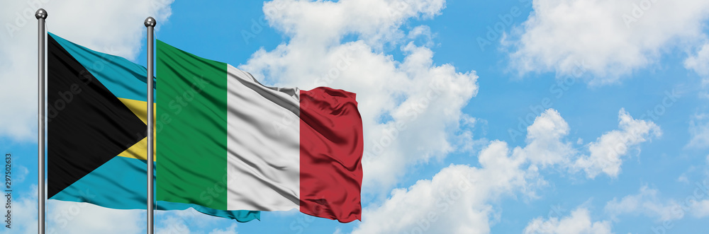 Obraz premium Bahamas and Italy flag waving in the wind against white cloudy blue sky together. Diplomacy concept, international relations.
