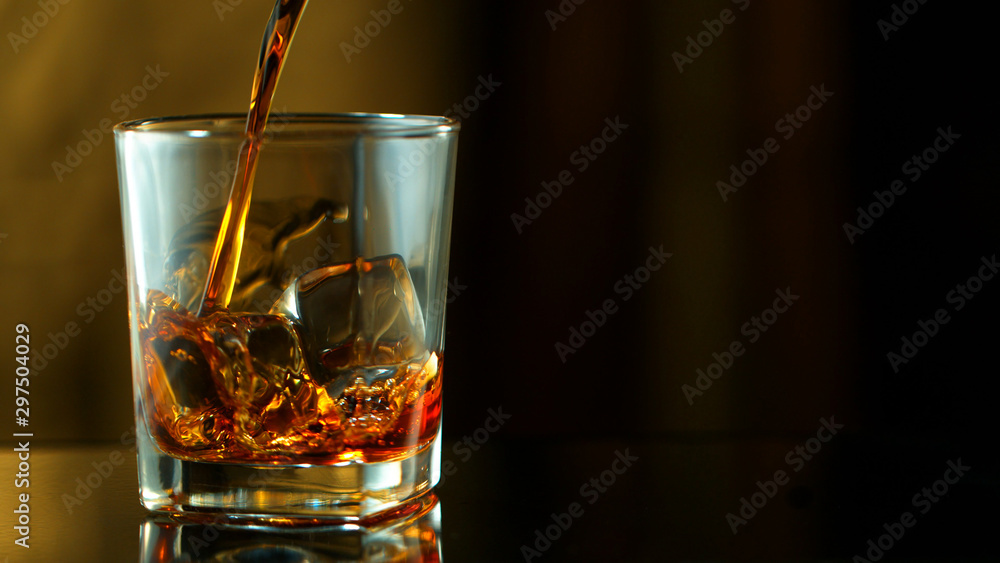Pouring whiskey into glass Pouring whiskey into glass