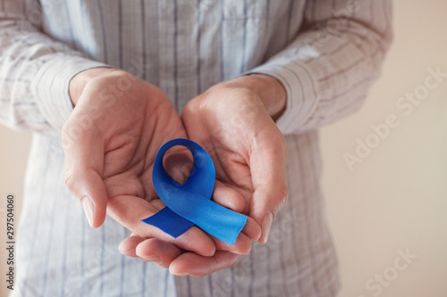 Man Hands holding blue ribbon  Prostate Cancer Awareness  November blue  Movember Men health awareness  world diabetes day