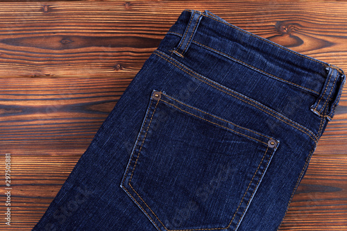 blue denim jeans on wooden background .