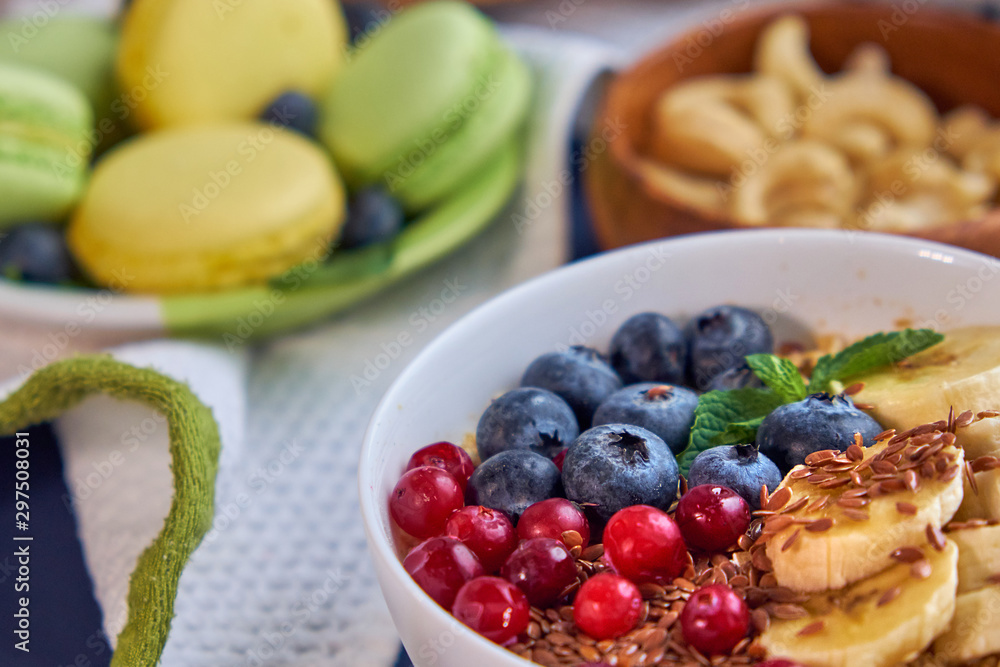 breakfast top view black background. oatmeal with berries, toasts on a wooden tray, nuts, coffee breakfast top view black background. oatmeal with berries, toasts on a wooden tray, nuts, coffee