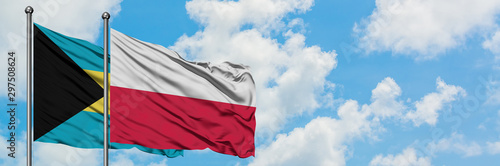 Bahamas and Poland flag waving in the wind against white cloudy blue sky together. Diplomacy concept, international relations.