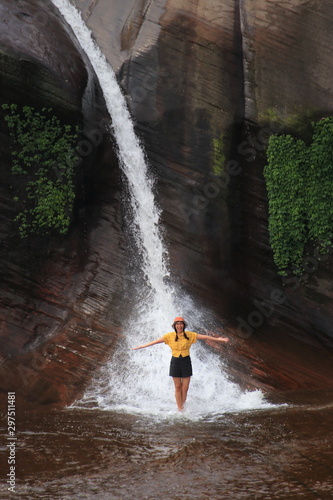 Women playing in the water at Tham Phra Waterfall  in Bueng Kan, Thailand.