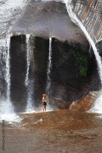 Women playing in the water at Tham Phra Waterfall  in Bueng Kan, Thailand.