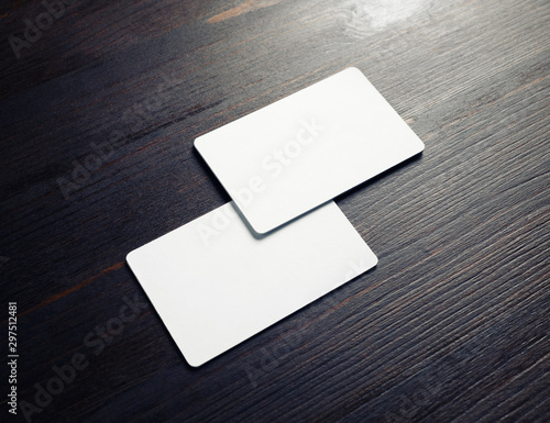 Photo of two blank white business cards on wooden background. Branding ID template.